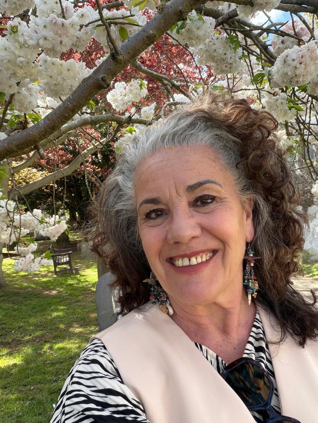 Leah smiling under blossom